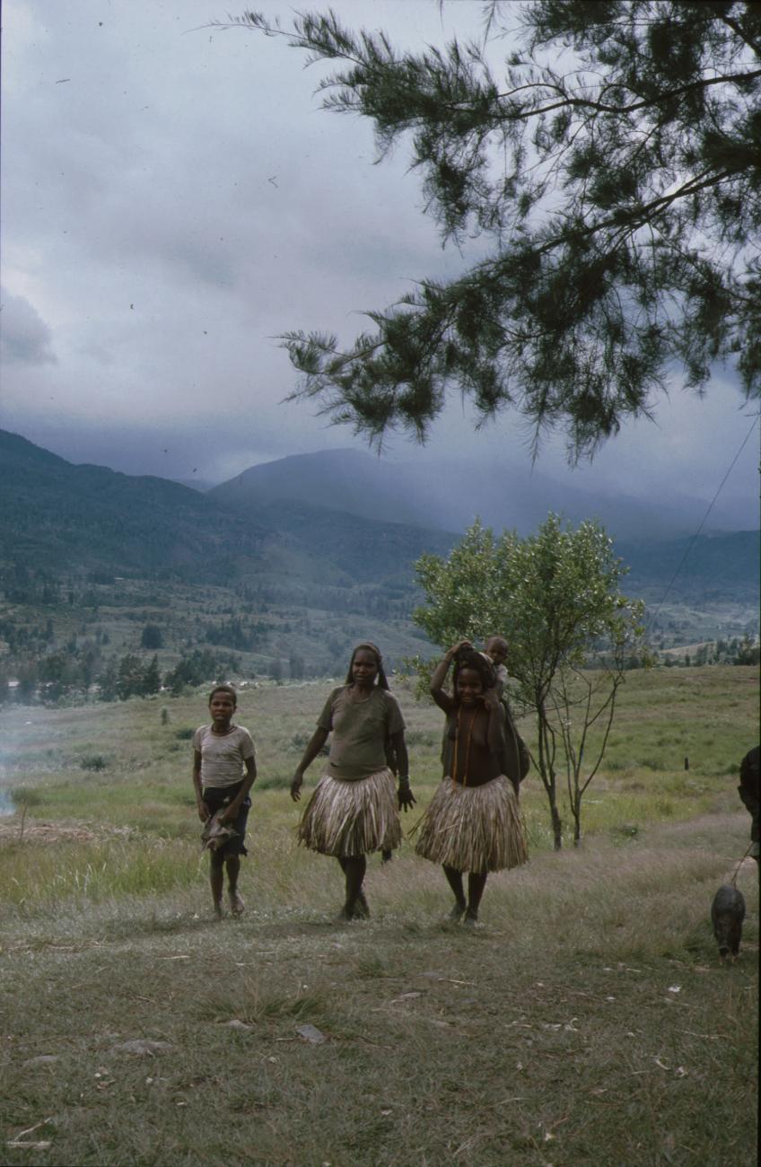 BD/166/158 - 
Two women and a boy walking on a path in the village
