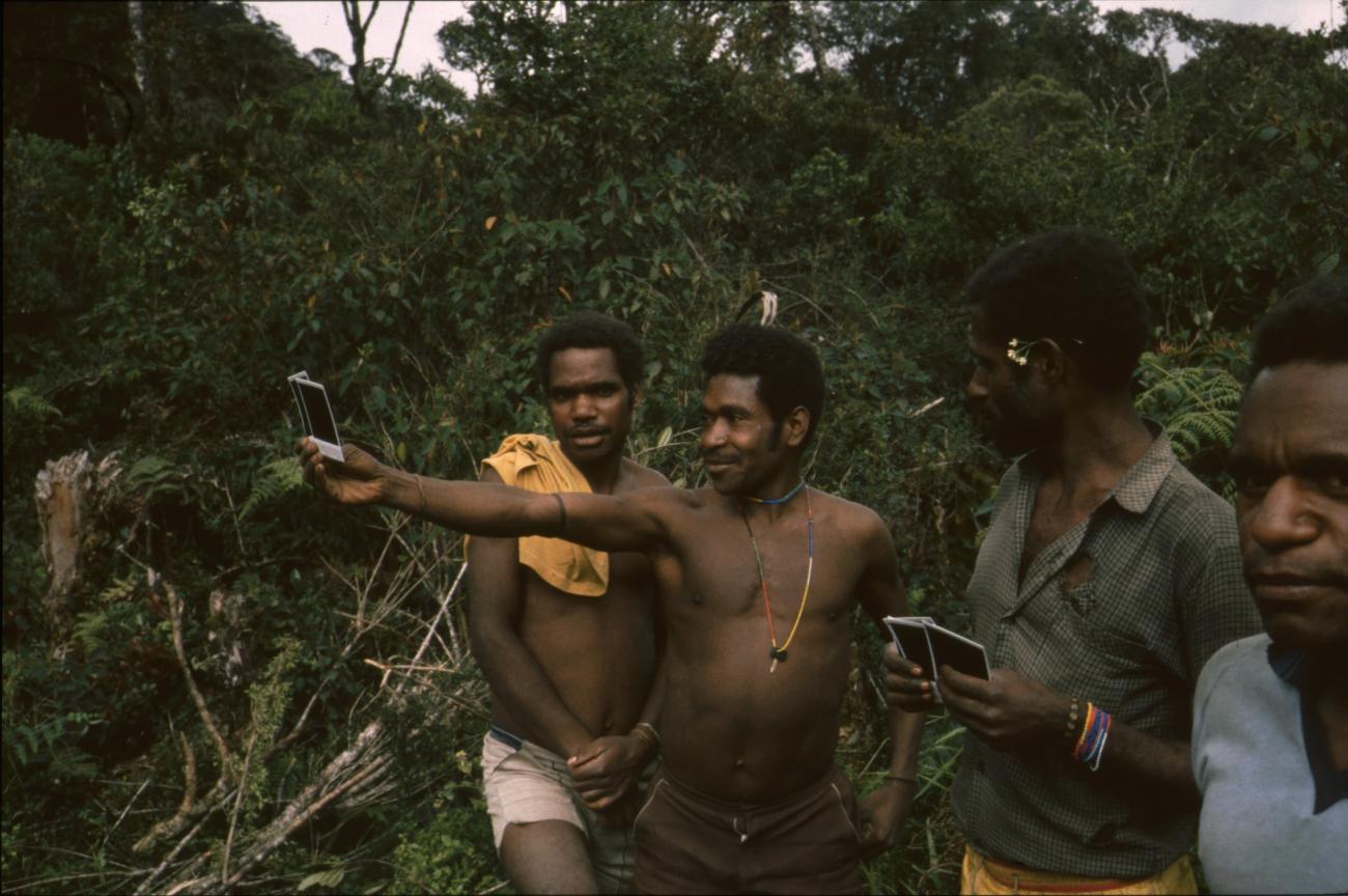 BD/166/15 - 
Group of men with tools and Polaroids
