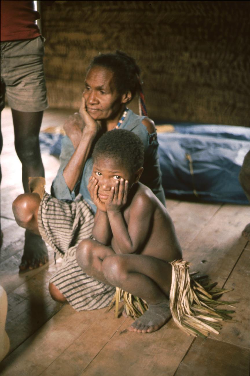 BD/166/184 - 
Squating girl in a hut

