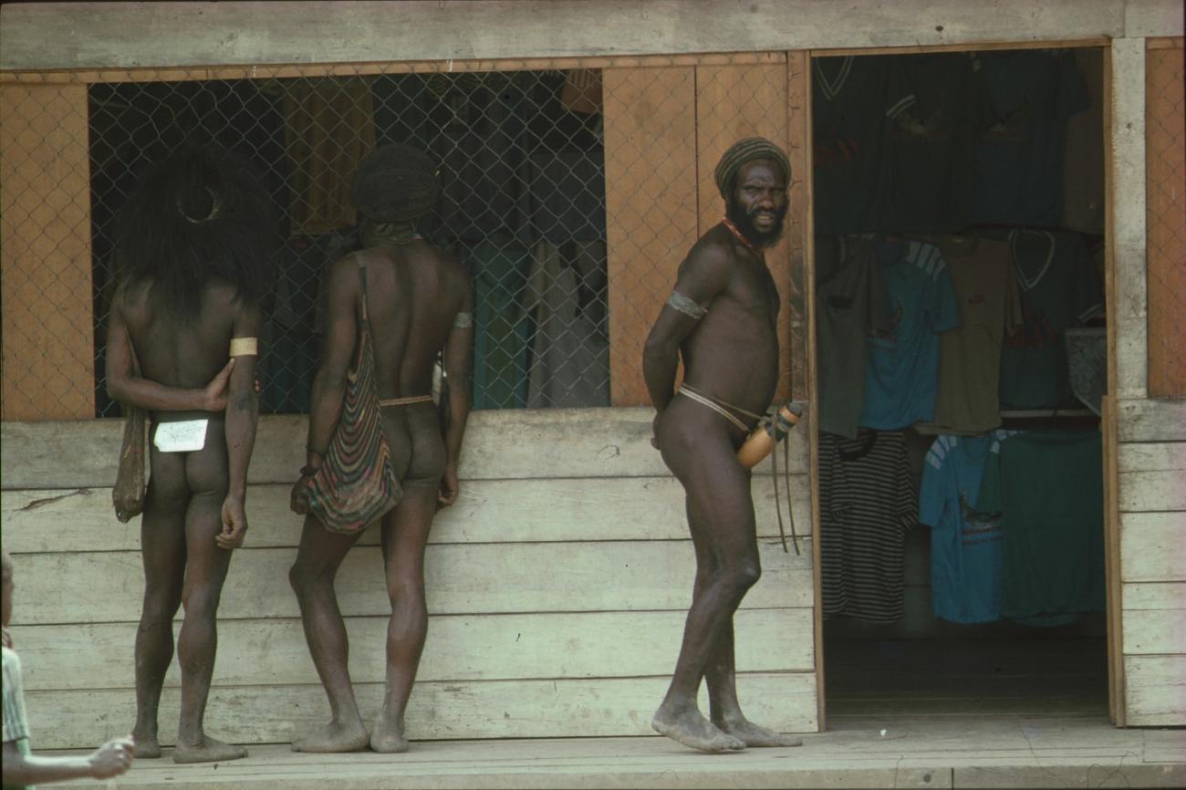 BD/166/208 - 
Three men in front of a clothing store
