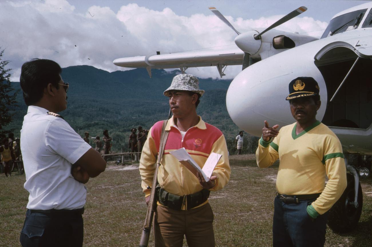 BD/166/219 - 
Three men on front of a plane
