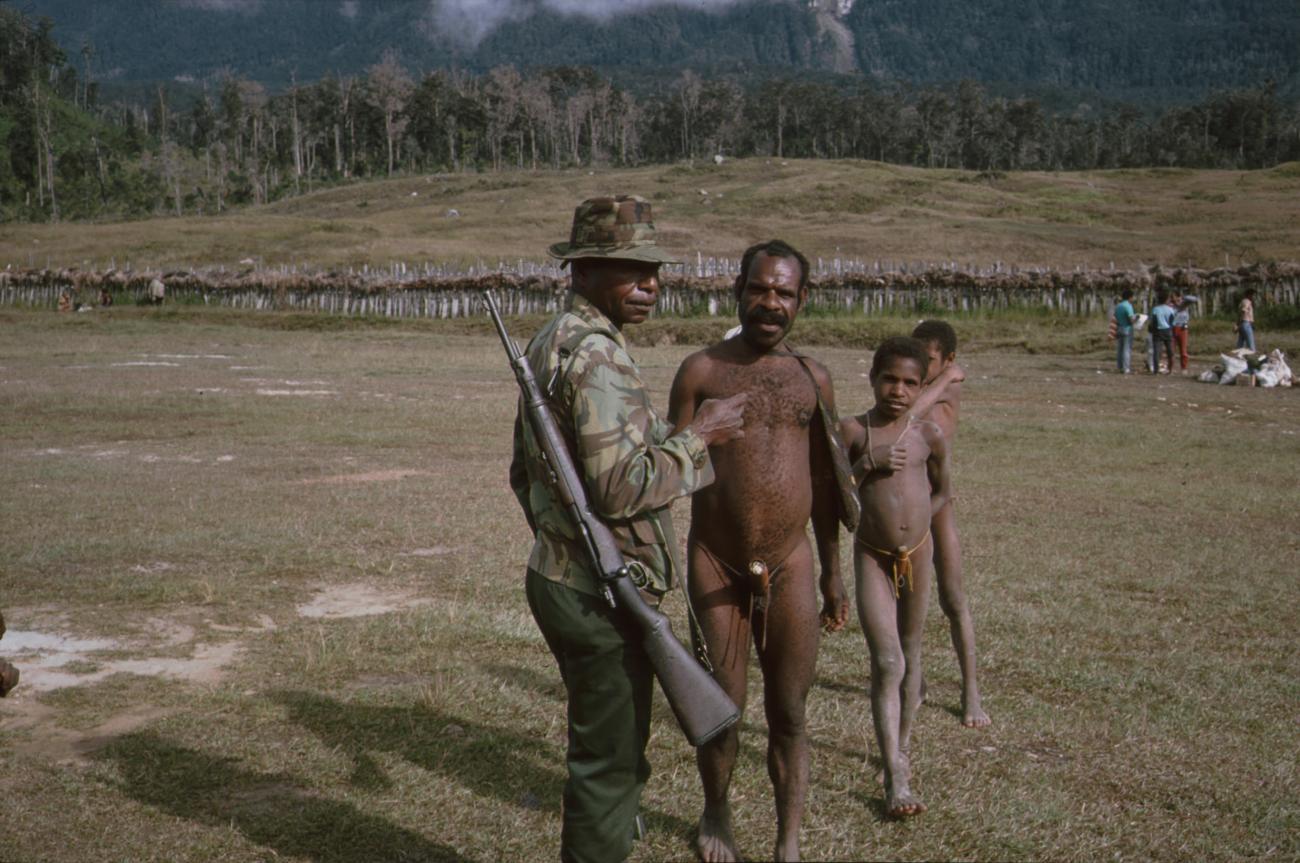 BD/166/329 - 
Group of Papua men in the open field
