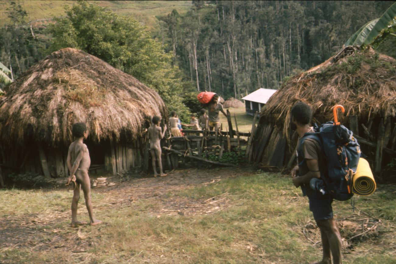 BD/166/419 - 
Porters with western luggage and an umbrella
