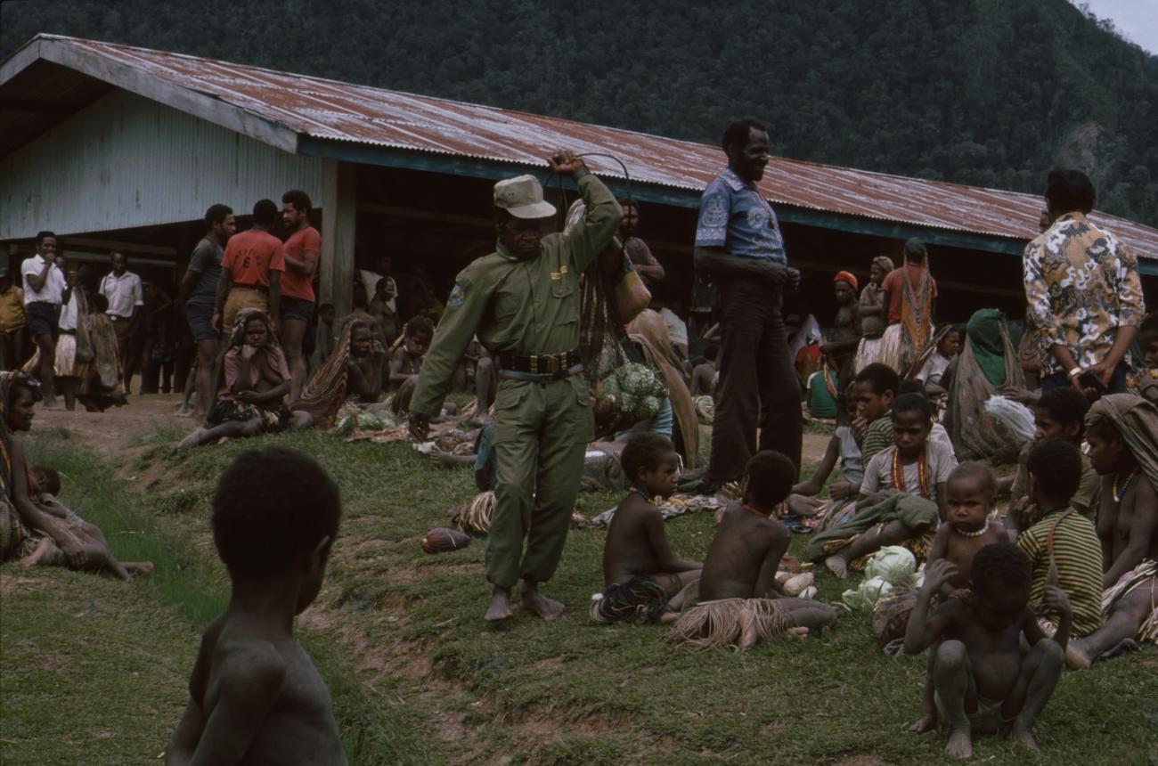 BD/166/47 - 
Man in green overall in the market
