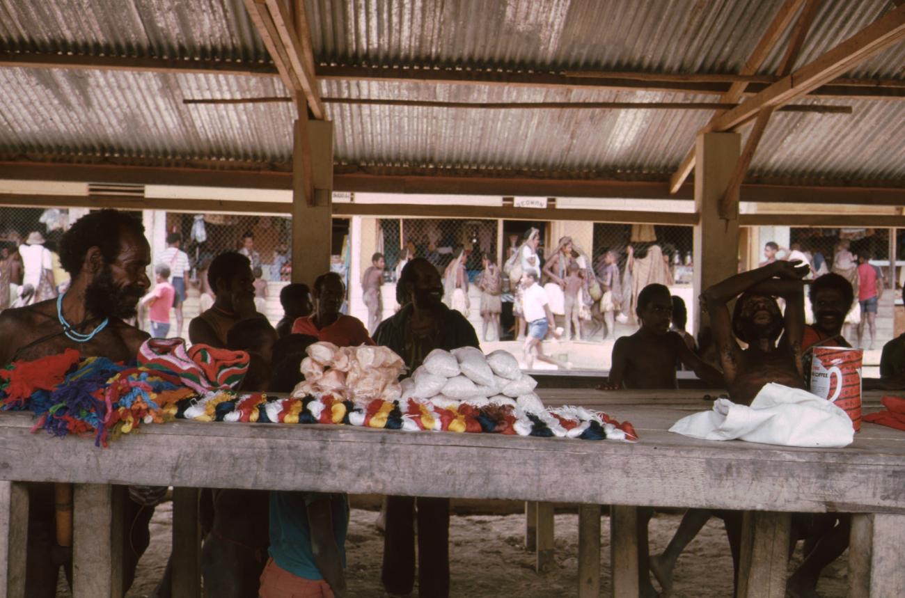 BD/166/75 - 
Textile and packaged food is displayed on covered market 3
