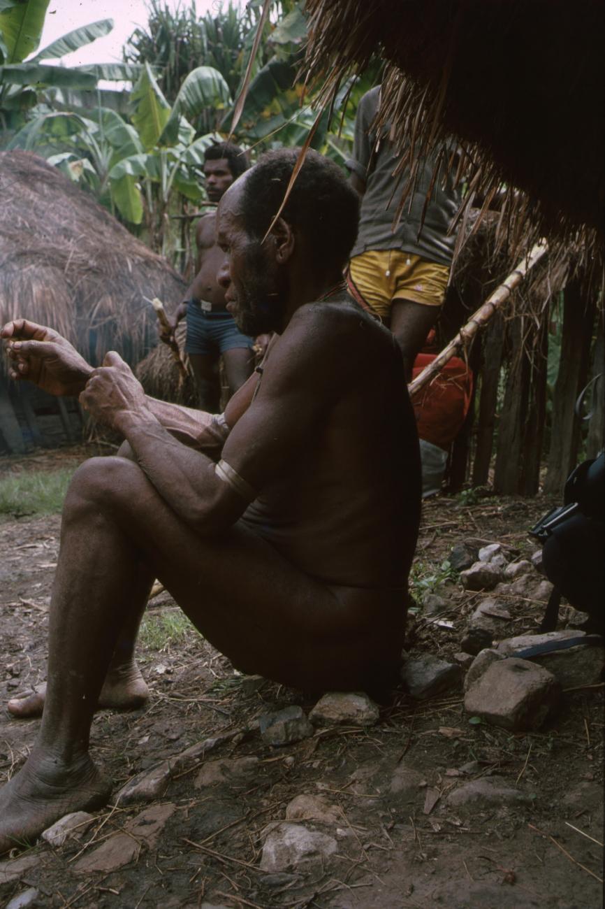 BD/166/78 - 
Man sitting on a row of stones 1
