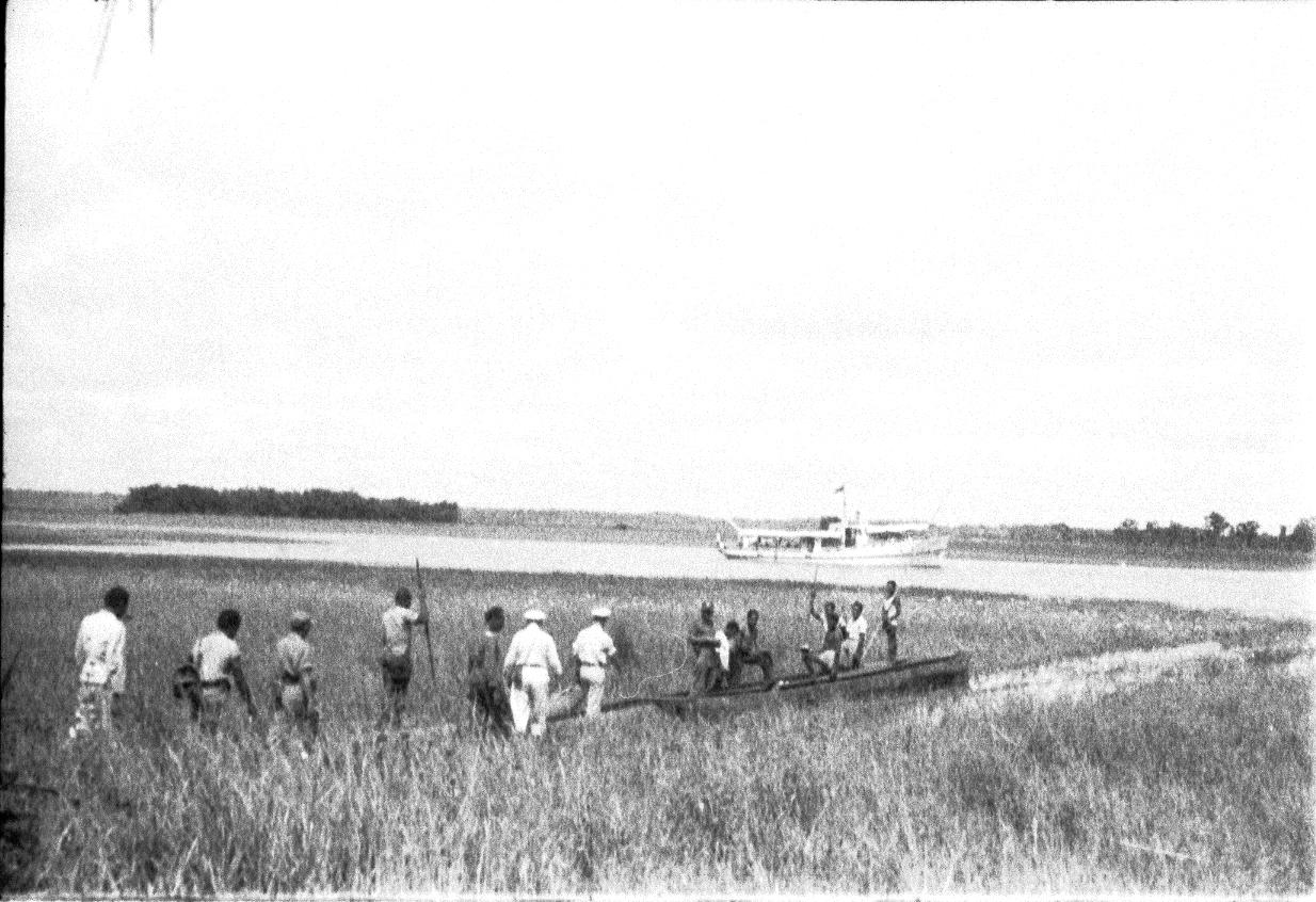 BD/67/235 -
Mensen onderweg door het water, tussen het riet