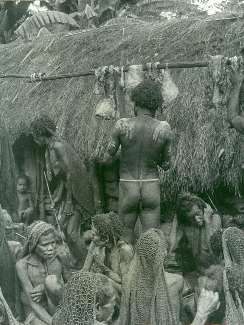 BD/40/24 -
Mountainland inhabitants busy with hanging meat ready for preparation