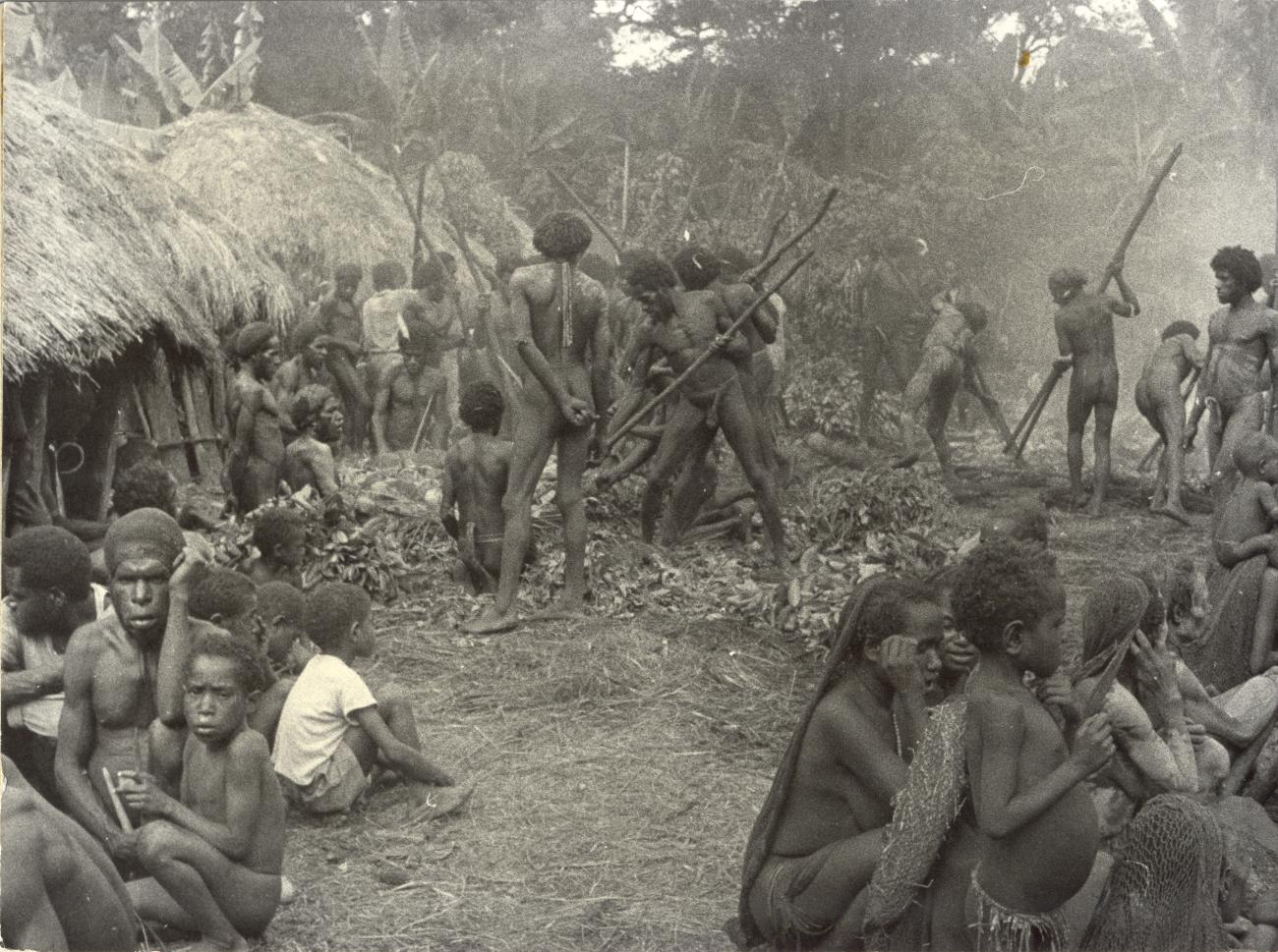 BD/40/7 -
Mountainland inhabitants preparing food in a village during a pig feast