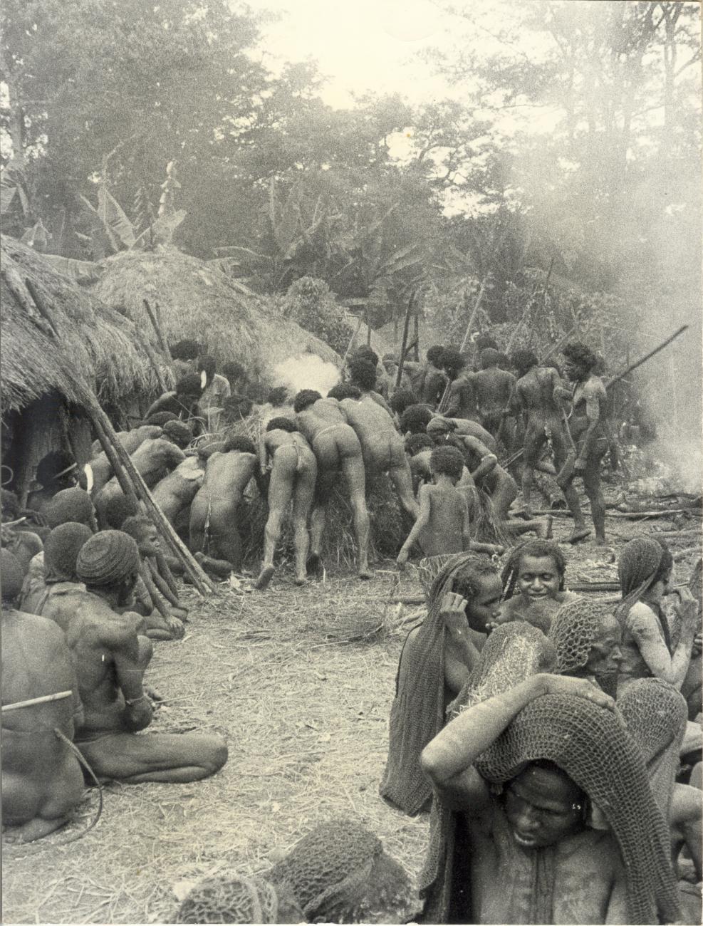 BD/40/8 -
Mountainland inhabitants preparing food in a village during a pig feast